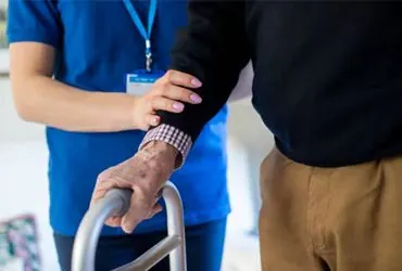Physiotherapist assisting a patient with home exercises